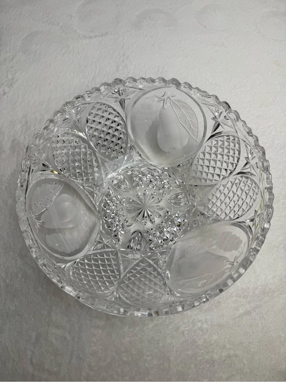 This vintage crystal cut and pressed pear and grape etched footed bowl 8.5”